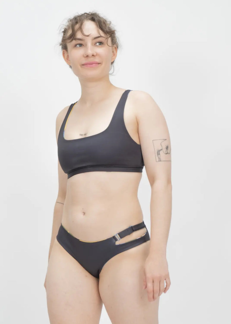 A black two-piece athletic swimsuit with a sports bra style top and bikini bottom.